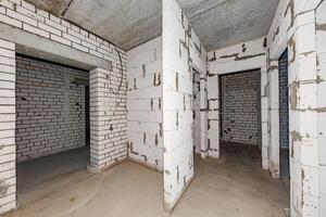 Echoes of Potential A Raw Canvas with Exposed Brick and Open Doorways Awaiting Transformation photo