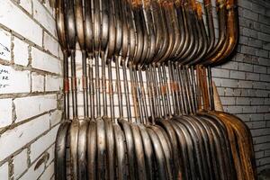 Vertical Symphony An Array of Industrial Metal Tubes Elegantly Intertwined with the Rustic Texture of Brick. photo