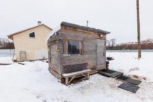 Snow-Kissed Retreat A Weathered Cabin Nestled in Tranquil White Blankets photo