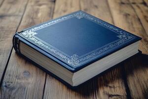 book in a dark blue cover with silver embossing on the spine, lying on a wooden surface photo