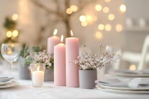 table setting with pink candles standing on a white tablecloth with gray accents photo