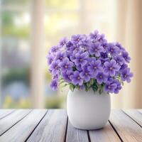 elegant bouquet of purple flowers with bright accents placed on wooden table photo