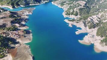 Scenic glass terrace overlooking turquoise menzelet dam lake waters, revealing dramatic kahramanmarash mountain terrain spreading across rugged turkish landscape video