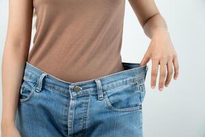 showing results of diet. Beautiful shape. female have a reduced waist size after under going a weight loss corse. can not wear jeans due to weight loss. balance, control, routines, exercise. photo