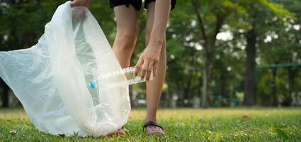 Save earth. Volunteer pick up trash garbage at the park and plastic bottles are difficult decompose prevent harm. Earth, Environment, Greening planet, reduce global warming, Save world photo