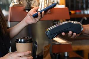 Woman use smartphone to scan QR code for order menu in cafe restaurant with a digital delivery. Choose menu and order accumulate discount. E wallet, technology, pay online, credit card photo
