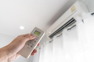 Man control air conditioner for energy saving, saving money, environmental conservation, reducing global warming, power photo