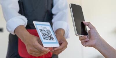 use smartphone to scan QR code to pay in cafe restaurant with a digital payment without cash. Choose menu and order accumulate discount. E wallet, technology, pay online, credit card, bank app photo