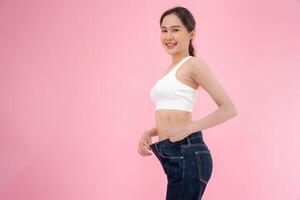 female showing results of diet. Beautiful shape. female have a reduced waist size after under going a weight loss corse. can not wear jeans due to weight loss. balance, control, routines, exercise. photo