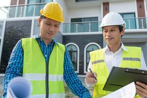 engineer and owner project is inspecting construction and quality assurance new house. Engineers or architects or contactor work to build the house before handing it over to the homeowner photo