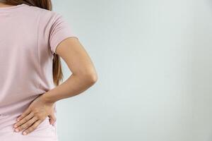 lower back while and suffer from unbearable pain health and problems, chronic back pain, backache in office syndrome, scoliosis, herniated disc, muscle inflammation. photo