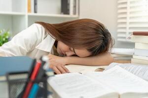 Asian student woman have anxiety because of exams, female prepare for test and learning lessons in the library. stress, despair, haste, misunderstanding reading, discouraged, expectation, knowledge. photo