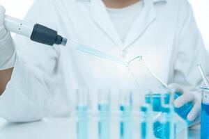 Scientist analyze biochemical samples in advanced scientific laboratory. Medical professional use dropper mix microbiological developmental of viral. Biotechnology research in science lab photo