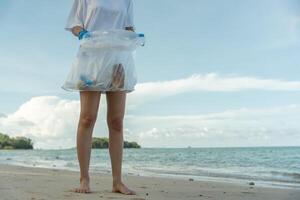Save ocean. Volunteer pick up trash garbage at the beach and plastic bottles are difficult decompose prevent harm aquatic life. Earth, Environment, Greening planet, reduce global warming photo