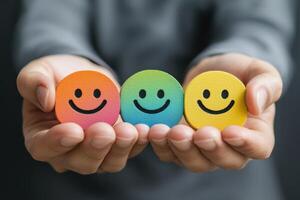 Colorful smiley faces in hands symbolize positivity and support photo