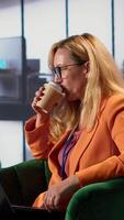 Vertical Woman CEO dealing with headache from burnout in a modern office space, discussing business growth and strategic planning. Leader emphasizing corporate feminism and gender equality. Camera A. video