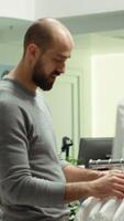 Vertical Modern stylish store employee helping a client explore clothing options, symbolizing a commitment to style and customer satisfaction. Diverse men discussing fashion expertise. Camera A. video