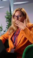 Vertical Female business leader in a collaborative meeting feeling sick and stressed, strategizing for corporate success with fatigue. Empowered woman being overwhelmed and tired under pressure. Camera B. video