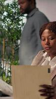 Vertical Successful businesswoman manages financial planning and project development. Focused female employee using her expertise achieve business objectives, administrative tasks. Camera A. video