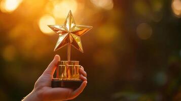 hand holding golden star trophy symbolizing achievement and recognition photo
