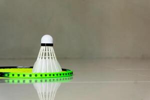 racket and shuttlecock on the floor, copy space photo