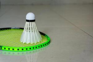 Badminton racket and shuttlecocks on green background. copy space photo
