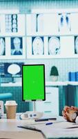 Vertical Specialist discussing x ray imaging with a patient next to isolated mockup display, presenting healthcare diagnosis during check up visit. Physician sharing the treatment plan and advice. Camera B. video