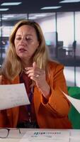 Vertical Team of business colleagues study feedback on old projects to improve their work for the future, developing an expansion plan in meeting room. Ambitious powerful women with skill. Camera B. video
