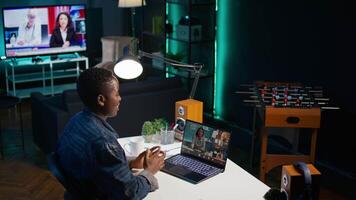Smiling employee saluting managers, using online videocall to ask for feedback on project progress. Cheerful worker waving hand, greeting coworkers in teleconference meeting, camera B video