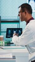 Vertical Medical expert and patient meeting at a check up appointment to discuss lab test results and potential treatment for recovery. Healthcare industry with medical insurance services. Camera A. video
