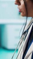 Vertical Indian medical staff and male patient engaging in a check up exam with diagnostic tools and test results for scan interpretation. Showcasing healthcare practices and research. Camera A. video