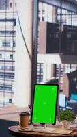 Vertical Group of businesswomen using green screen mockup on tablet in a briefing meeting, exchanging ideas and details about a future project. Ambitious female leaders planning a strategy. Camera A. video