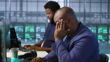 Stressed engineer finally relaxing after receiving access granted notification while reconfiguring server hub. Tense admin lightens up after managing to successfully eliminate all errors video
