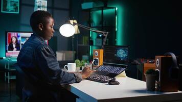 AI professional in home office using laptop to write programming language code. Artificial intelligence engineer working from home using notebook device to build application, camera B video