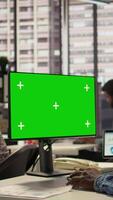 Vertical Woman at her desk working on data analysis next to mockup display, engaged in business tasks and budget management to drive effective corporate strategy. Analyst reads reports numbers. Camera B. video