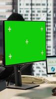 Vertical Male executive seated at his workstation with isolated copy space multitasking, analyzing financial reports to support strategic business goals and decision making processes. Camera A. video