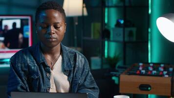 Focused freelancer working from home, typing on laptop, writing in document. Remote employee scrolling on digital device and sending emails to business associates, camera A close up video
