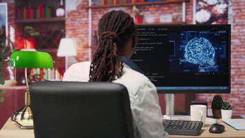 Admin writing code on computer and doing maintenance on artificial intelligence neural networks computerized model. Tech support expert typing on keyboard, doing checkup on AI systems, camera B video