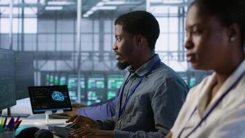 Data center software developer maintaining company network infrastructure by configuring and troubleshooting hardware. Close up of woman in server hub ensuring optimal system performance, camera A video
