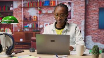 Woman enjoying leisure time at home, drinking coffee, texting friends on laptop. Cheerful person talking with mates on social network online website, using notebook, camera B video