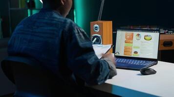 Accountant working from home taking notes on financial documents, analyzing sales report to plan business development. Remote employee using marketing statistics charts for project research, camera A video