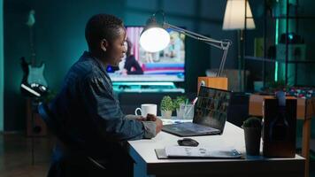 Remote worker greeting colleagues during business meeting on videocall in apartment office. Self employed woman participating in remote videoconference telework call while at home, camera A video