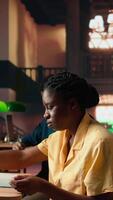 Vertical College student underlining relevant phrases from the class notes using a highlighter pen, learning only the important ideas for the upcoming exam. Smart preparation with the summary. Camera A. video