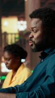 Vertical African american college student feels frustrated and overwhelmed with the learning struggles, worried depressed pupil struggling to memorize information from class notes. Camera B. video