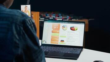Woman in home office holding teleconference meeting with coworkers using smartphone, brainstorming ideas. Remote worker in online phone videocall with colleagues analyzing research, camera A video