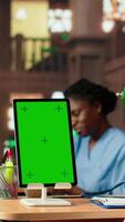 Vertical African American pupil learns to become a doctor with a green screen, reading and doing research at the med school library. Student preparing for tests to have a career in healthcare. Camera B. video