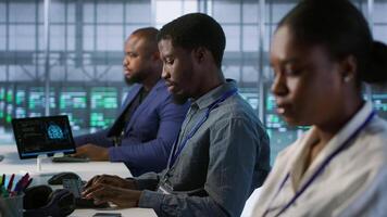 System administrators in data center implementing AI predictive maintenance systems. Teamworking server hub specialists using artificial intelligence to identify hardware failures, camera A video