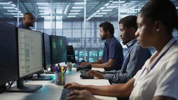 Cybersecurity specialists in server room trying to protect equipment from hacker stealing data. Programmers in data center office doing teamwork to delete virus attacking company servers, camera A video