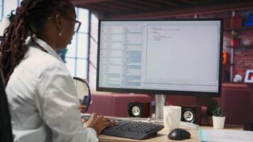 Woman feeling worried while looking at UI on PC screen, having trouble executing programming code. Anxious IT developer concerned by errors popping up while testing code in apartment, camera B video