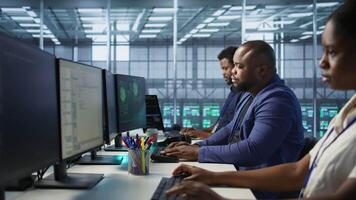 Surprised data center technician celebrating after successfully managing to install cybersecurity framework, reducing security incidents and enhancing data protection protocols, camera A video
